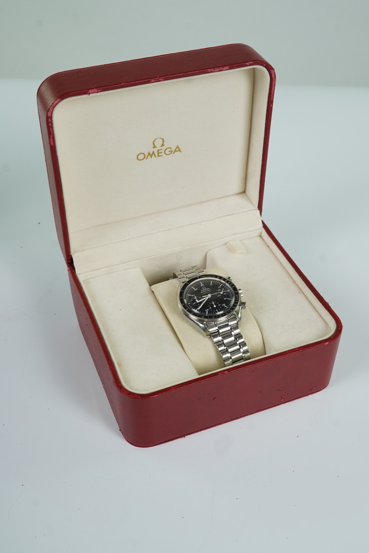 A gentleman's late 1990's stainless steel Omega Speedmaster automatic wrist watch, with box and three pamphlets